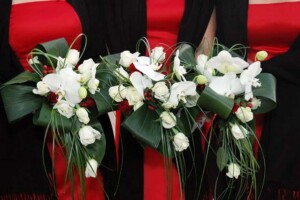 Trailing wedding bouquet with red roses with phalaenopsis orchids
