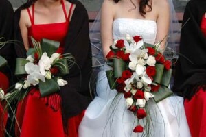 Trailing wedding bouquet with red roses with phalaenopsis orchids