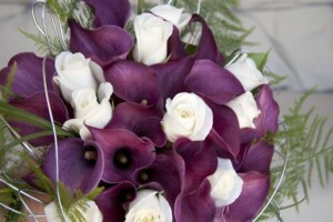 Hand tied wedding bouquet with white roses and calla lilies