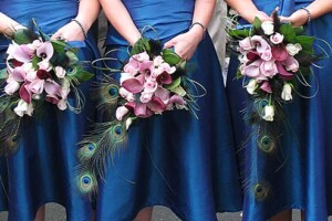 Trailing wedding bouquet with calla lilies, peacock feathers and white roses