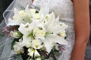 Trailing wedding bouquet of white roses, white lilies and jasmine