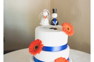 Wedding cake floral decorations with orange gerberas